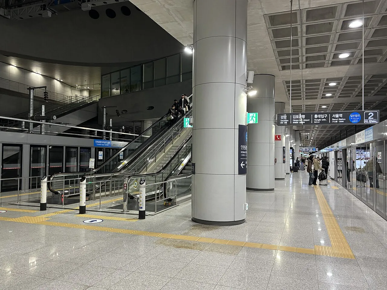 仁川空港第1ターミナル駅の一般列車ホーム。案内板に検岩・金浦空港・弘大入口・ソウル駅と行き先が並ぶ