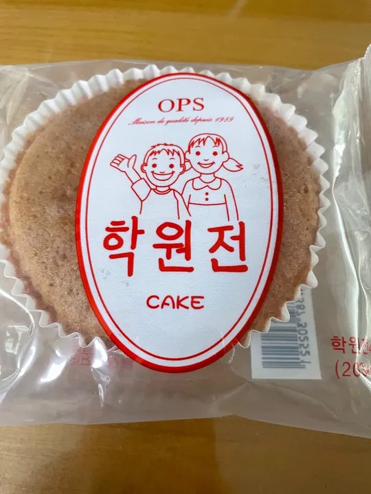 赤い楕円のラベルに「학원전」と書かれた、袋入りの丸いケーキ