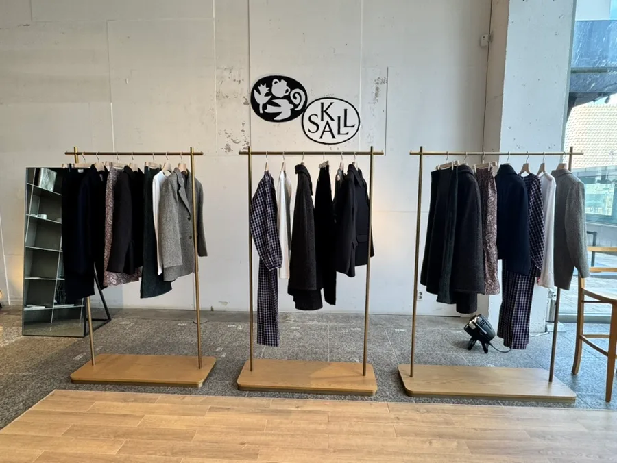 三つのラックに並ぶ服