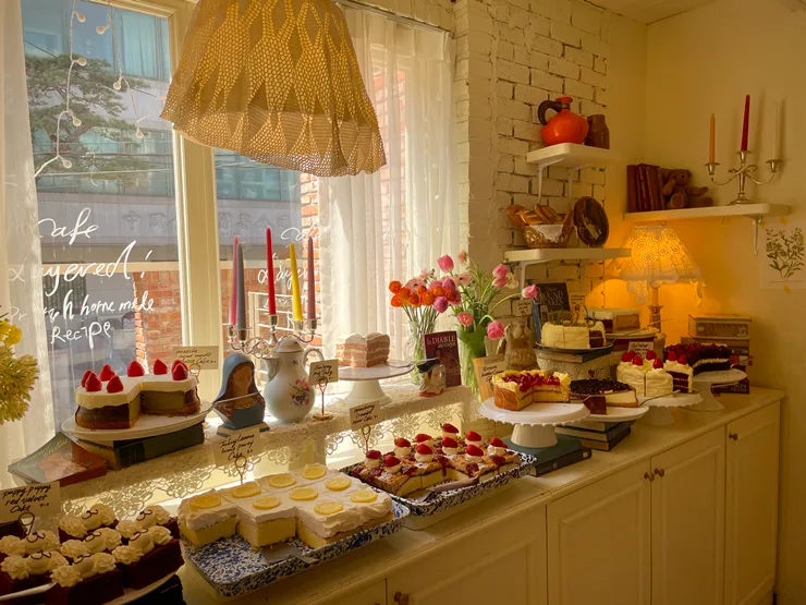 Cafe Layered 延南店 — ケーキが並ぶ暖色の窓辺