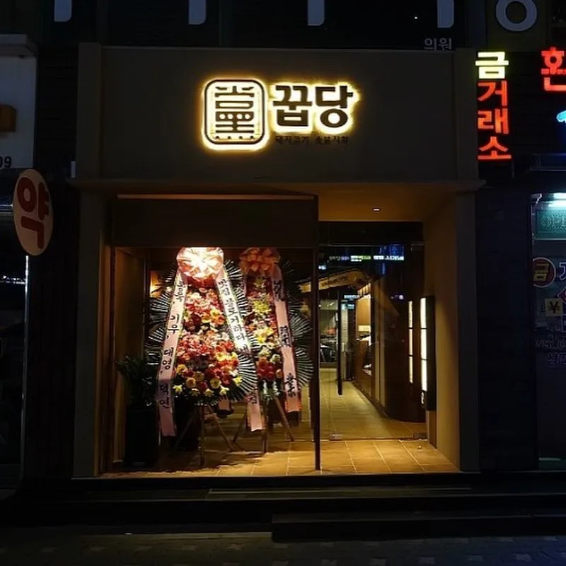 夜の看板と開店祝いの花輪