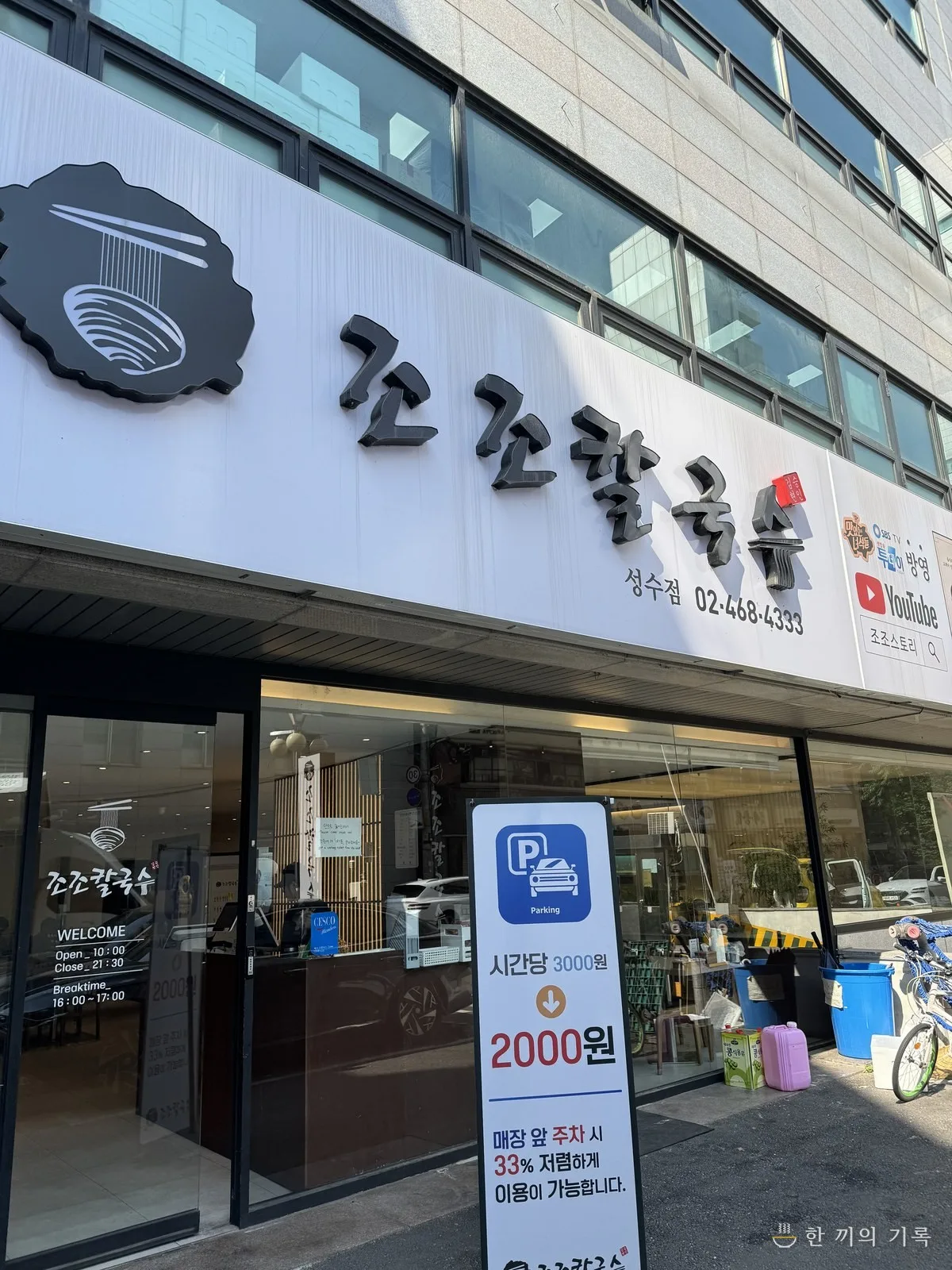 ジョジョカルグクス 聖水店 — 白壁に大きな黒文字の店名看板