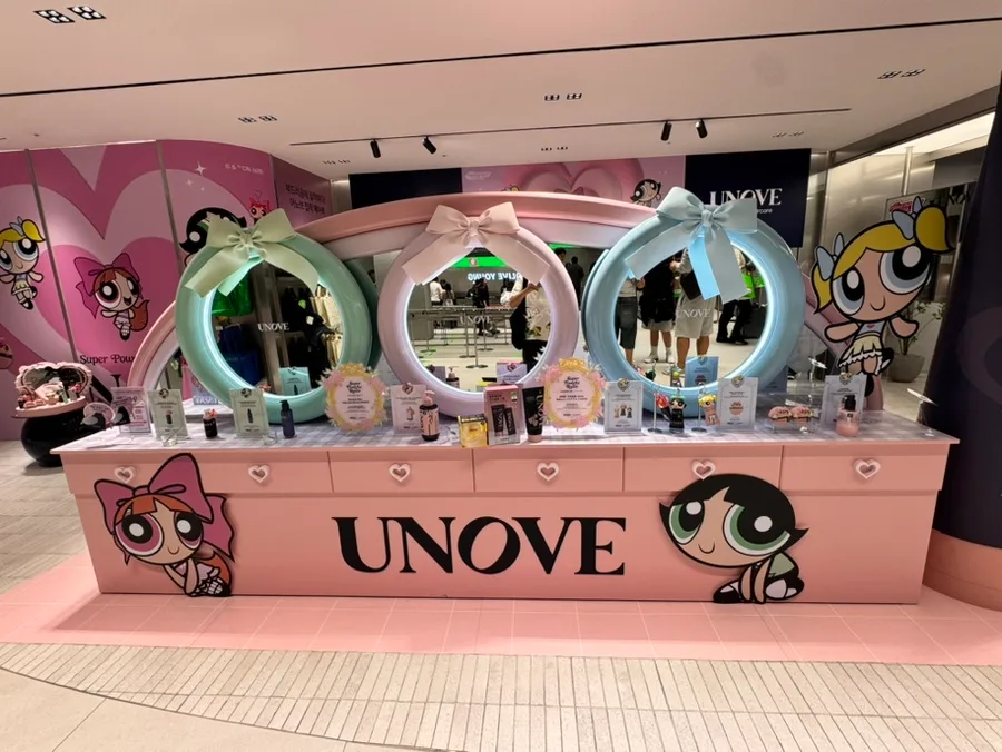 OLIVE YOUNG 明洞タウン店 — リボン鏡が並ぶピンクの展示台