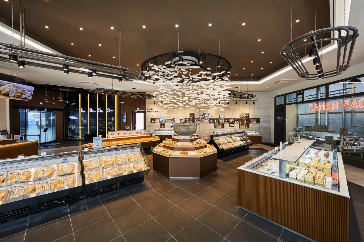 サムジンオムク 影島本店 — 魚形装飾を囲む商品ケース