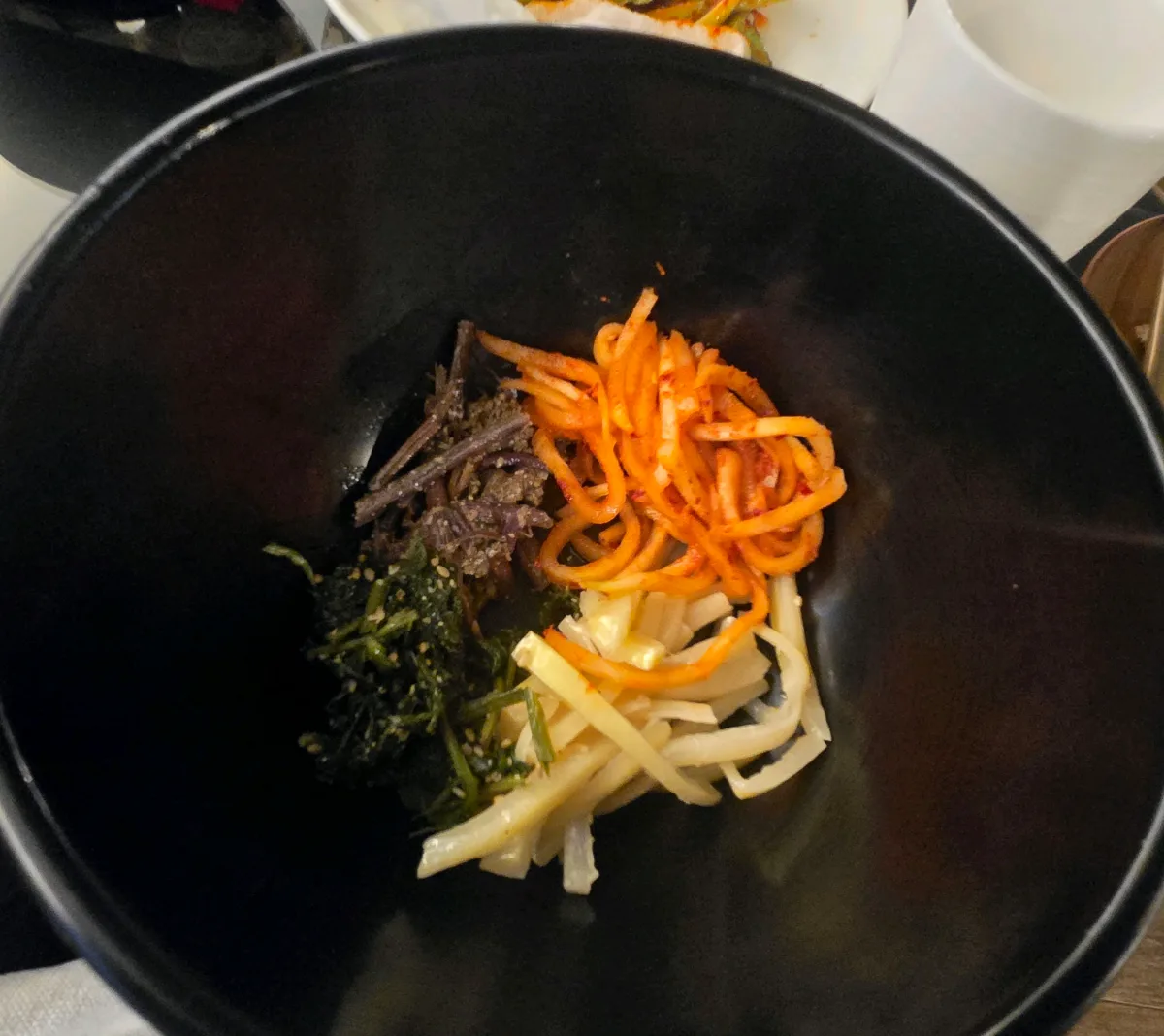 黒い器に盛られた山菜と野菜