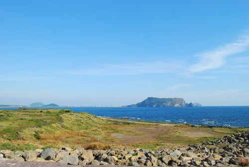 草原と海越しに望む峰