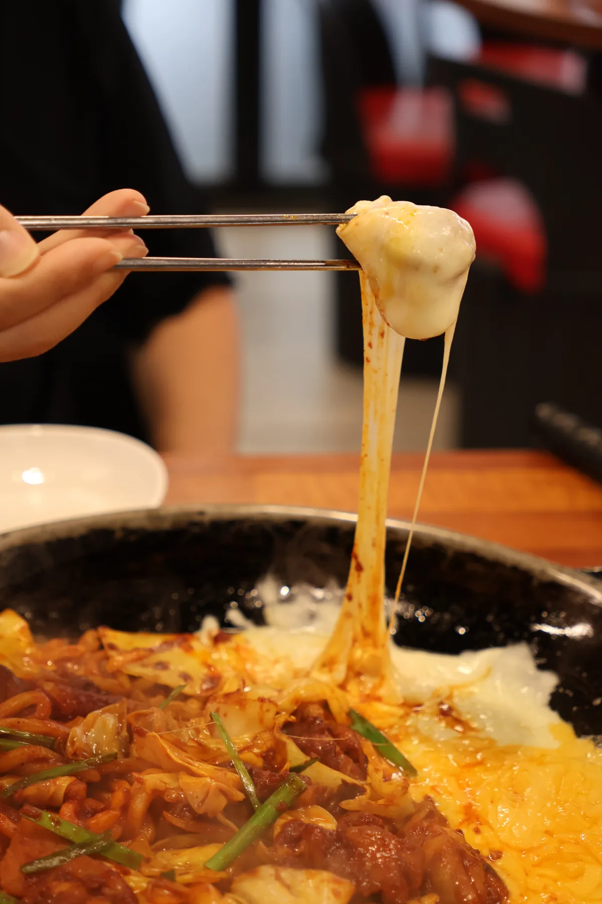 鶏肉から伸びる熱々のチーズ