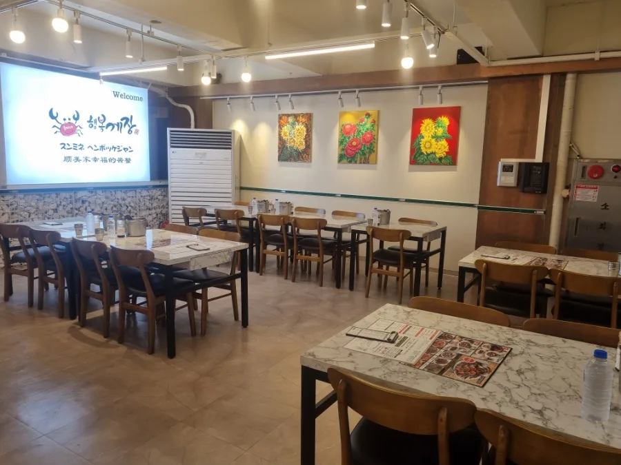 スンミネ・ヘンボッケジャン 東大門店 — 大理石調のテーブルが並ぶ店内