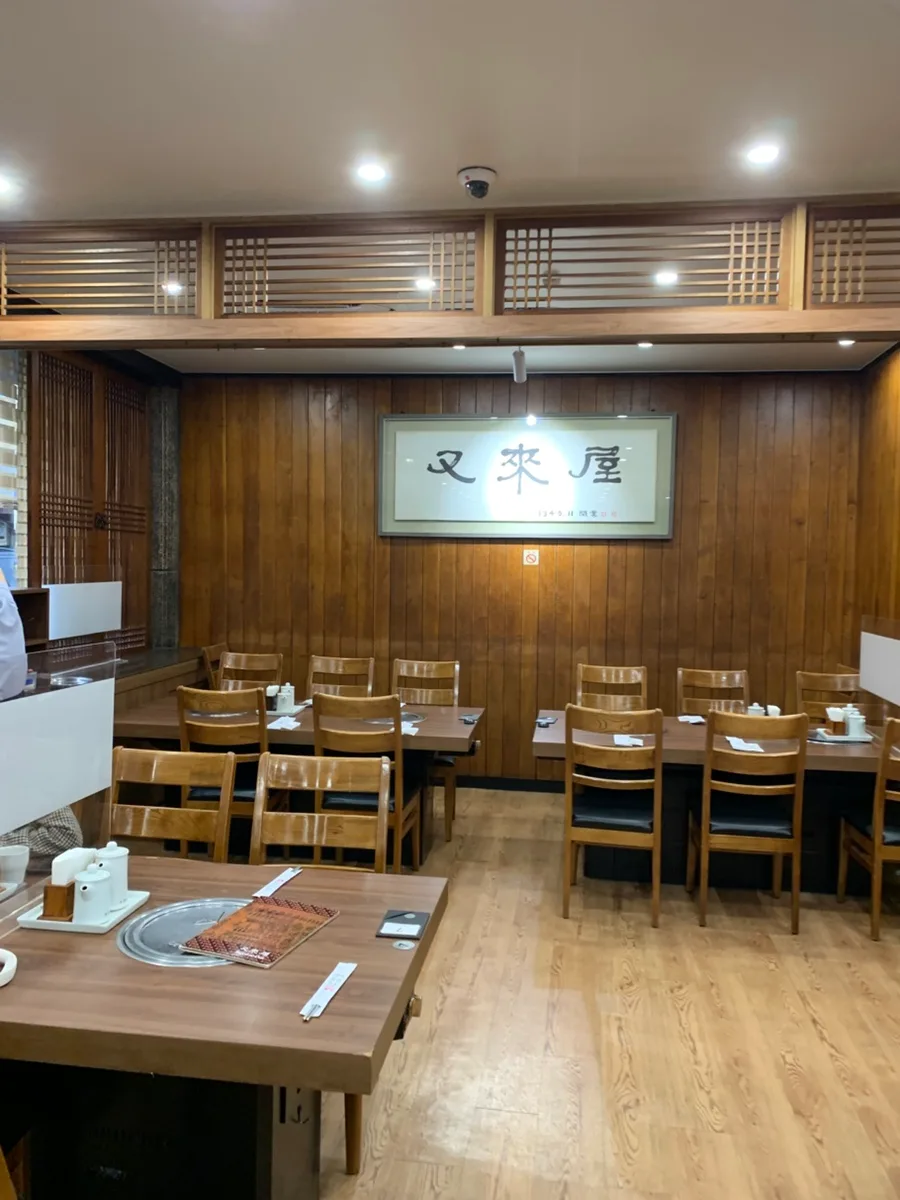 又来屋 — 店名額を飾った木壁の客席